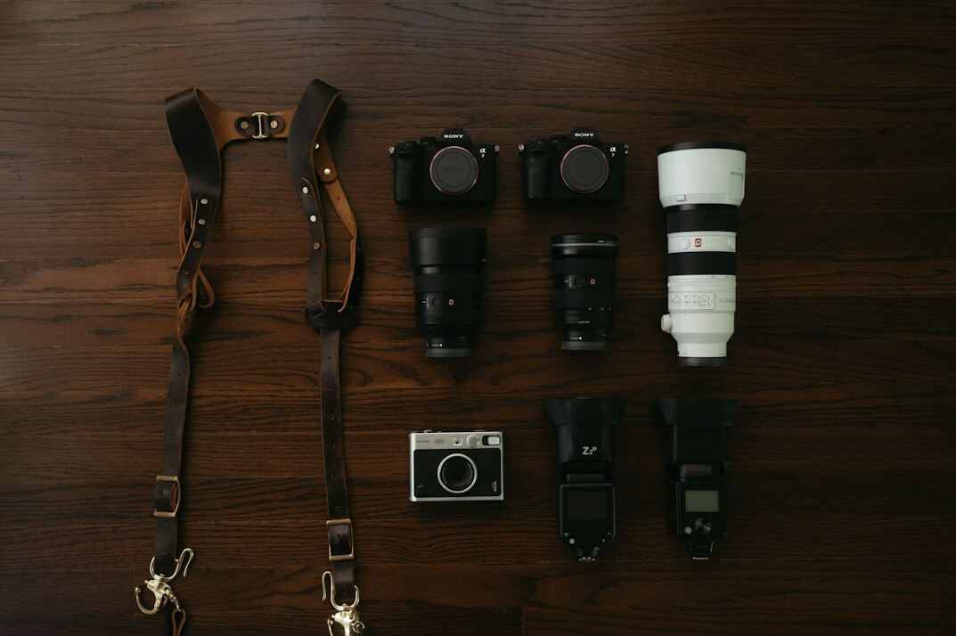 Camera equipment and film rolls on a wooden desk